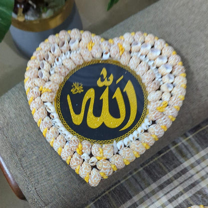 Heart-shaped decorative item with 'Allah' text on a textured surface