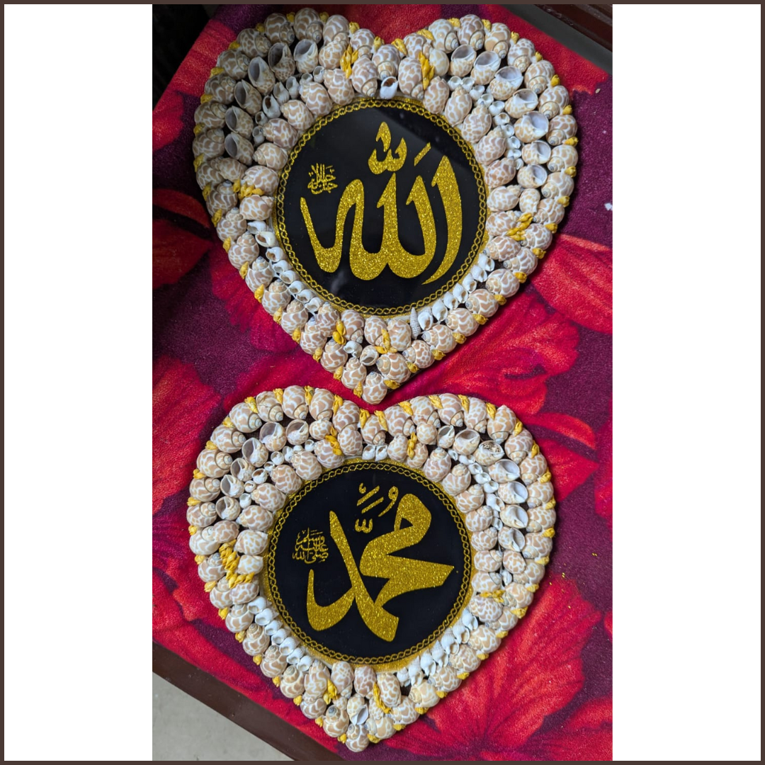 Two heart-shaped decorative items with 'Allah' Muhammad (SAW) symbol on a red fabric background