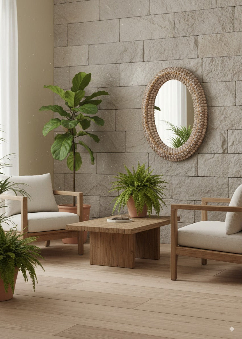 Living room with wooden furniture, oval shaped seashell handcrafted mirror plants, and a stone wall.