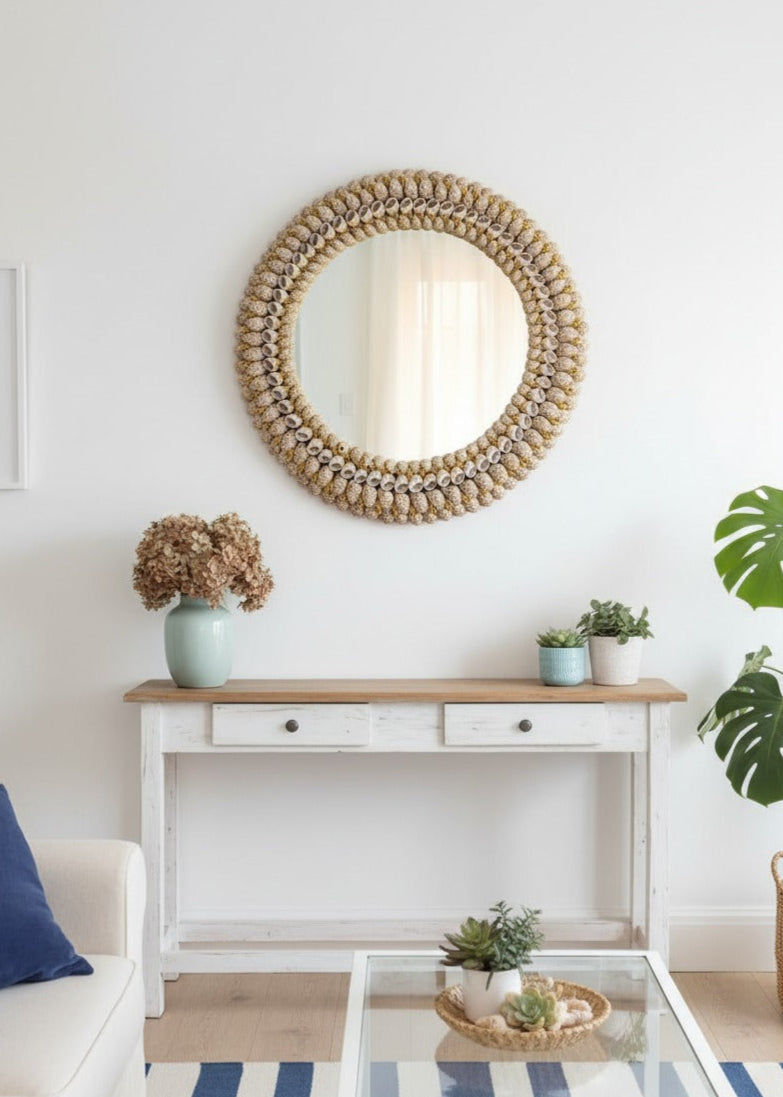 Living room with a round seashell mirror, console table, and decor items.